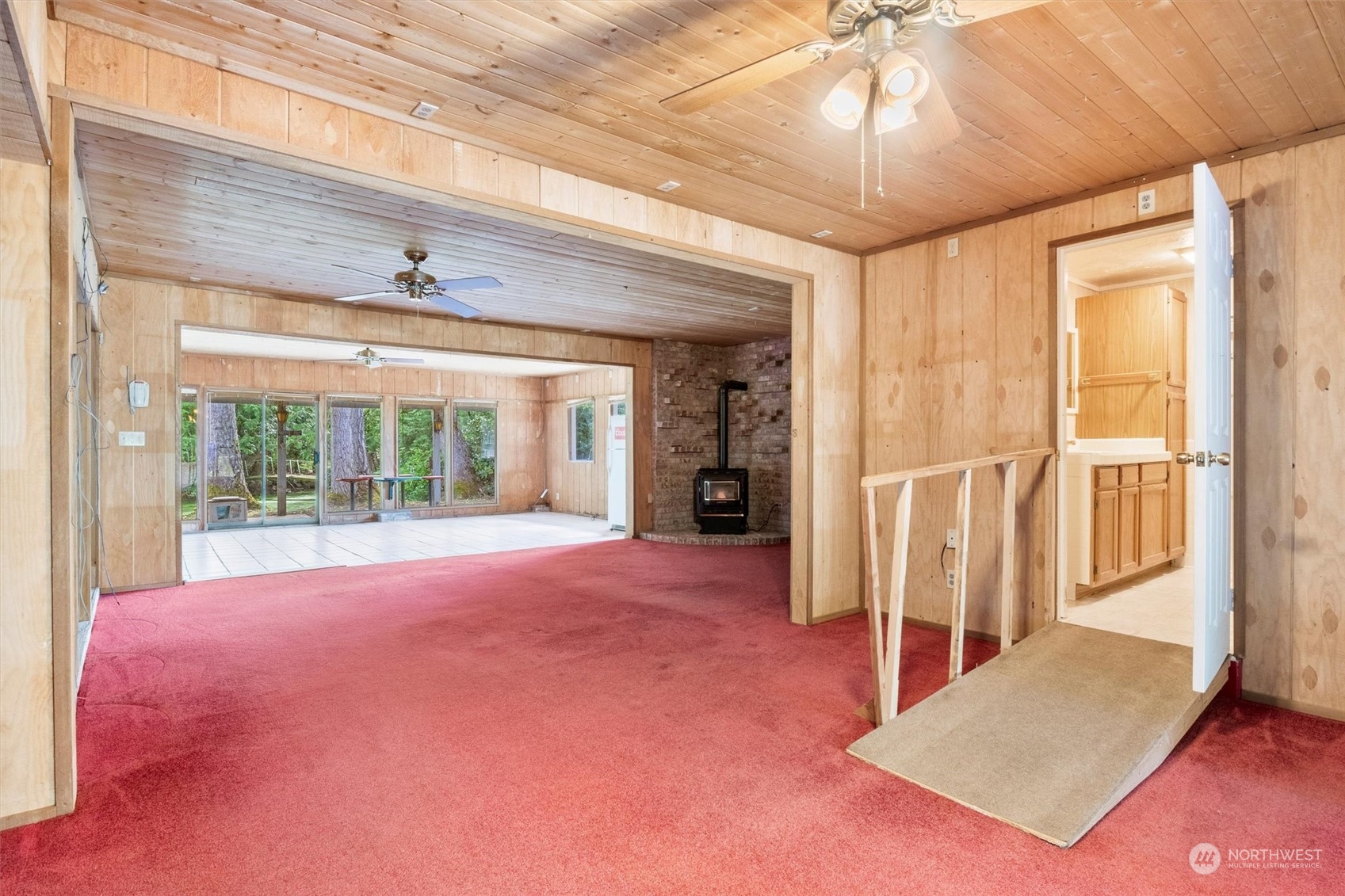 5570 Starry Road Bellingham, WA 98226 - Photo 28 of 34 a view of an empty room with a fireplace and a chandelier
