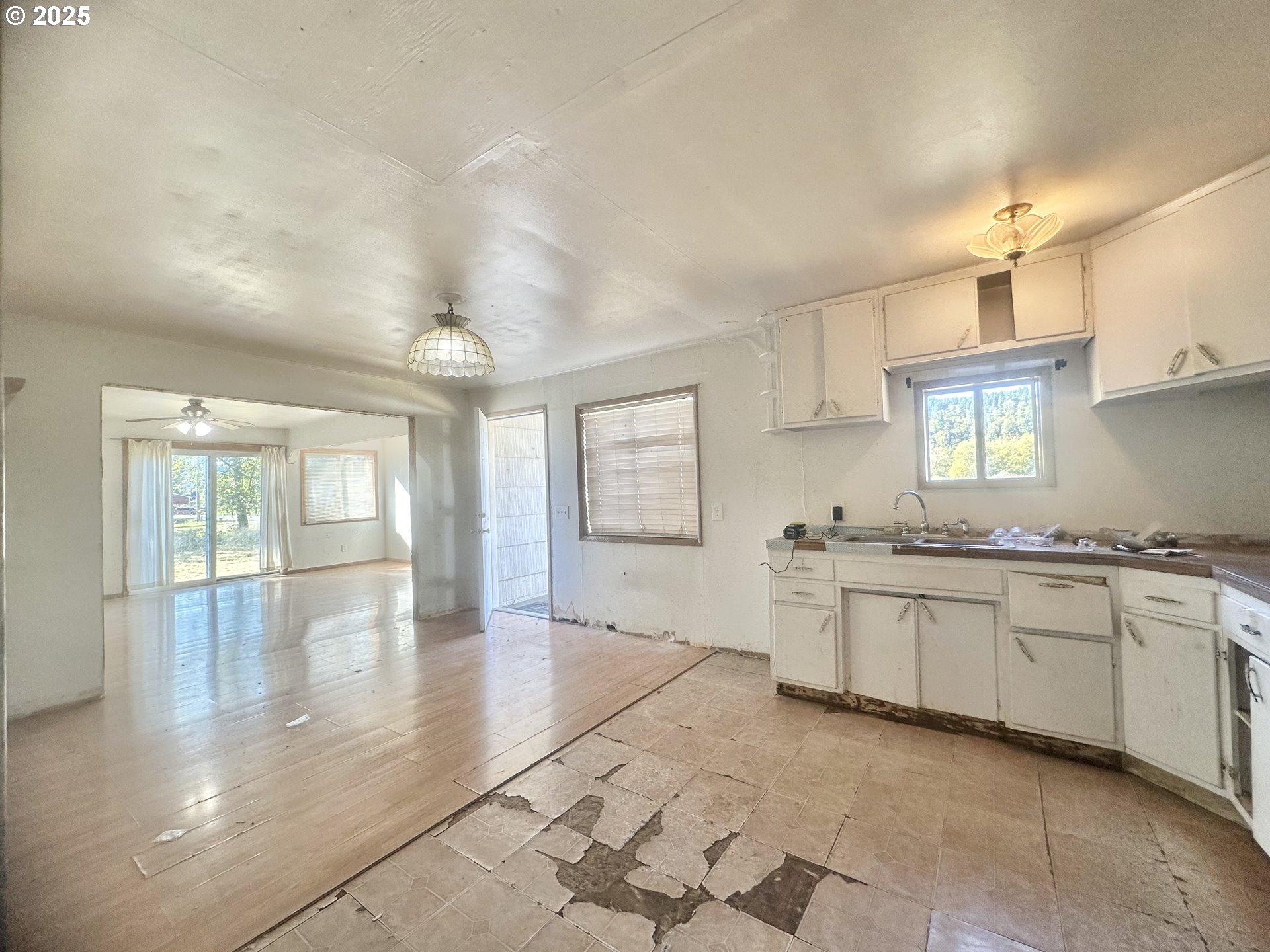 24275 Bunn Creek Road Cloverdale, OR 97112 - Photo 11 of 32 a large kitchen with granite countertop a stove a sink dishwasher and a black refrigerator