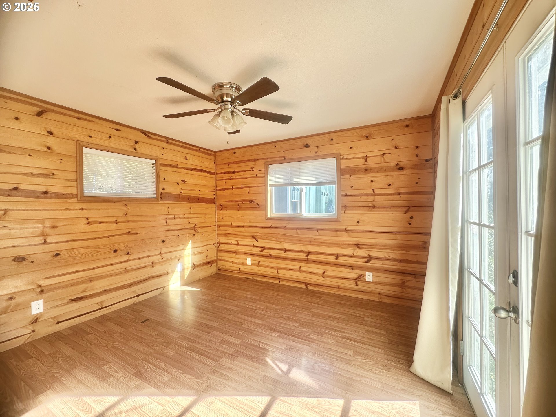 24275 Bunn Creek Road Cloverdale, OR 97112 - Photo 13 of 32 a view of empty room with wooden floor and fan