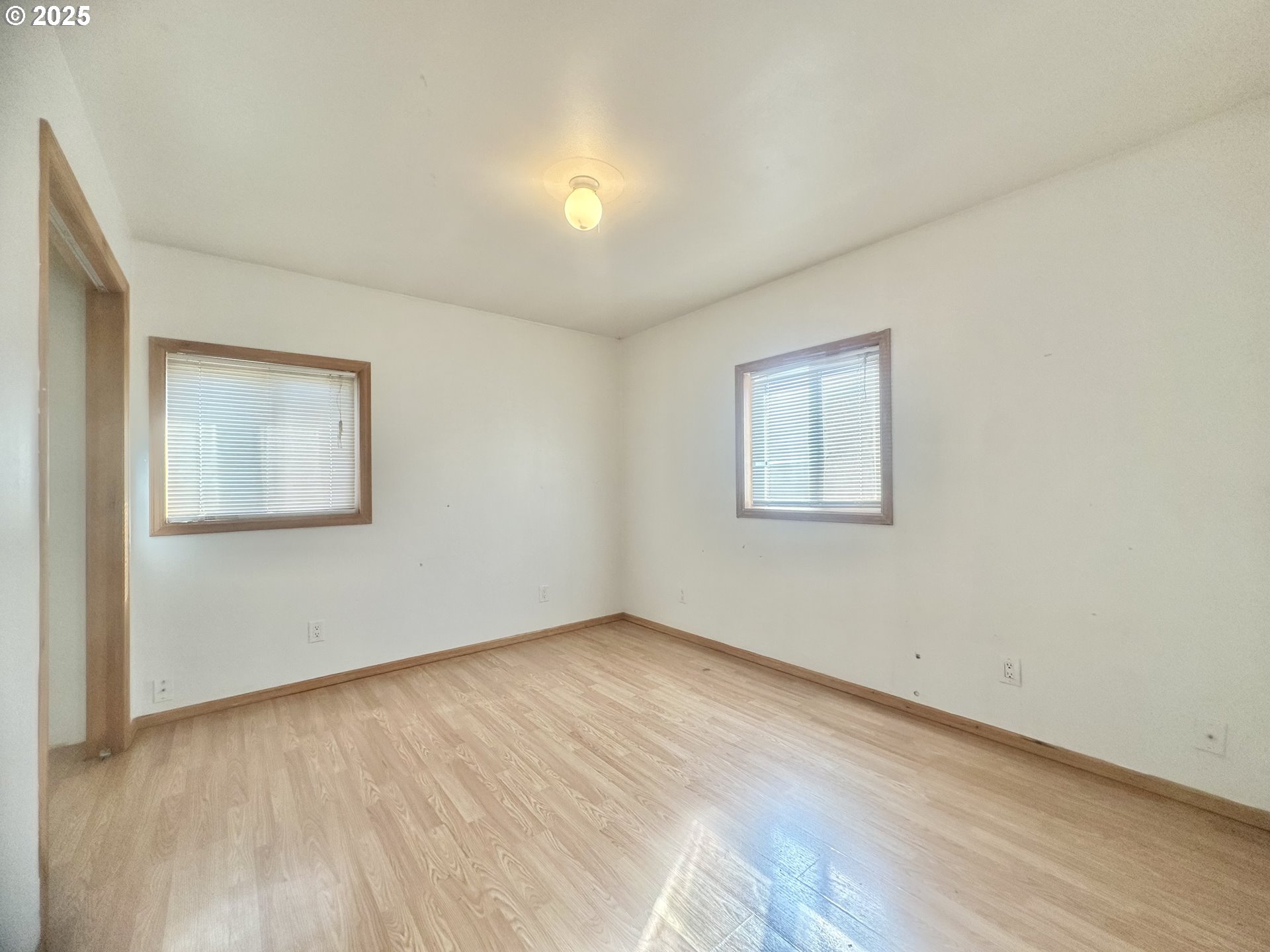24275 Bunn Creek Road Cloverdale, OR 97112 - Photo 17 of 32 a view of an empty room with wooden floor and a window
