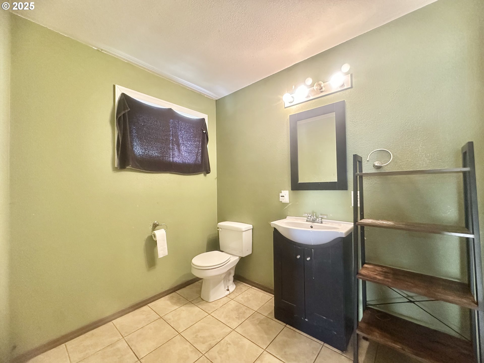 24275 Bunn Creek Road Cloverdale, OR 97112 - Photo 20 of 32 a bathroom with a double vanity sink mirror and toilet
