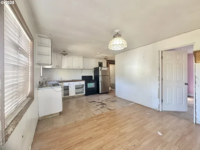 a view of a kitchen with a stove cabinets and a wooden floor