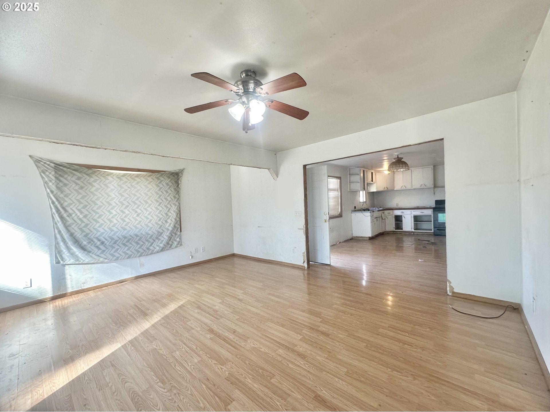 24275 Bunn Creek Road Cloverdale, OR 97112 - Photo 7 of 32 a view of an empty room with wooden floor and a window