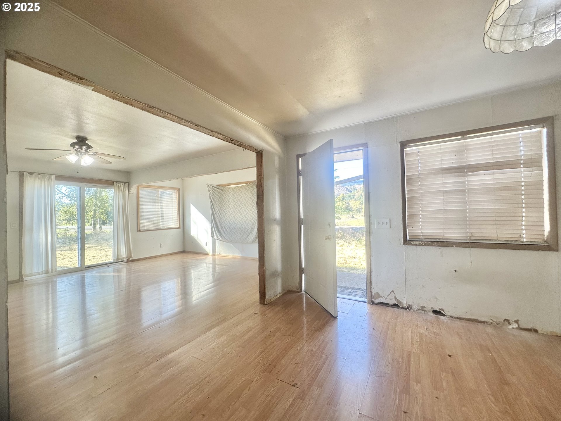 24275 Bunn Creek Road Cloverdale, OR 97112 - Photo 10 of 32 a view of an empty room with wooden floor and a window