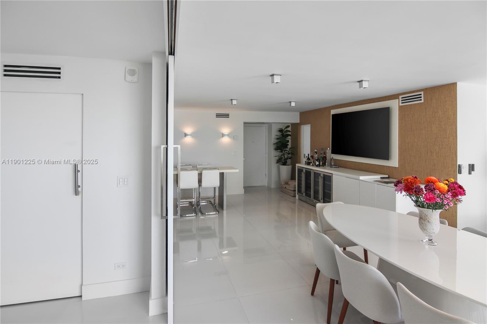 6039 Collins Avenue, Unit 1402 Miami Beach, FL 33140 - Photo 13 of 45 a view of a dining room with furniture