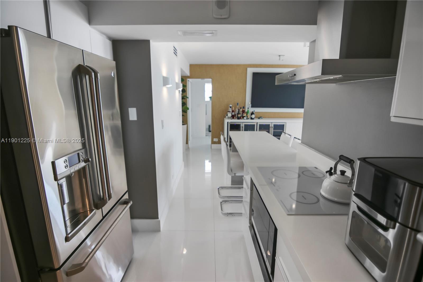 6039 Collins Avenue, Unit 1402 Miami Beach, FL 33140 - Photo 16 of 45 a view of a kitchen from a living room