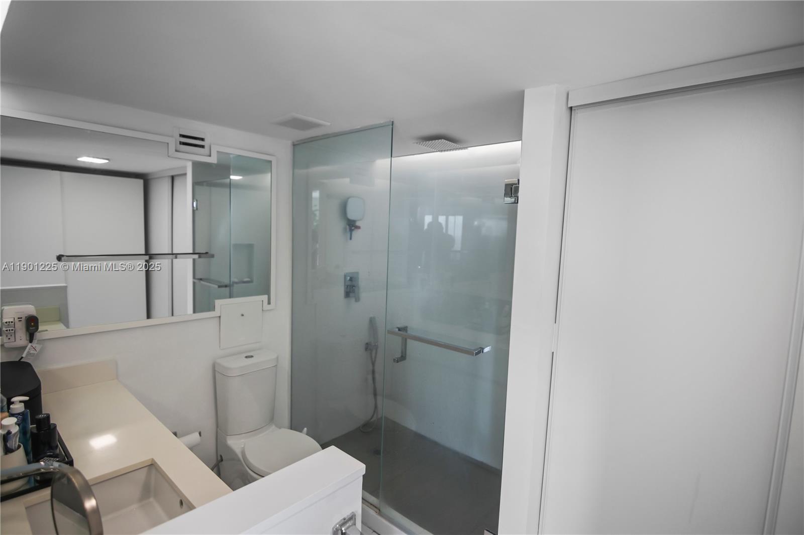 6039 Collins Avenue, Unit 1402 Miami Beach, FL 33140 - Photo 24 of 45 a bathroom with a shower toilet and sink