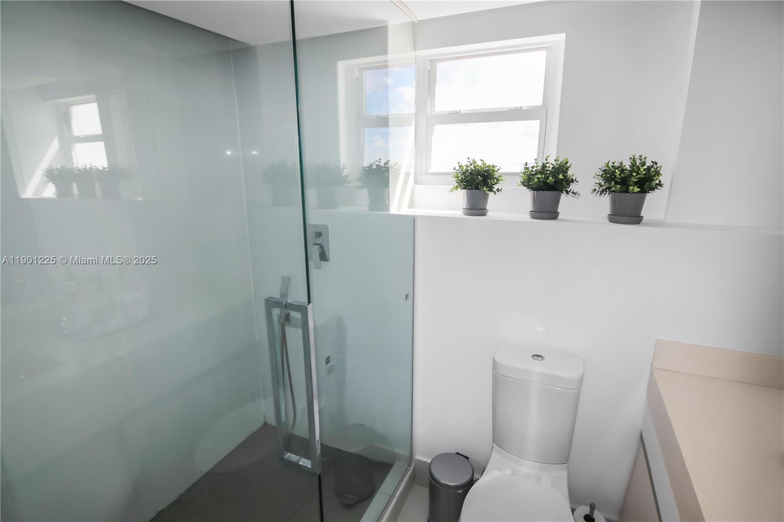 6039 Collins Avenue, Unit 1402 Miami Beach, FL 33140 - Photo 29 of 45 a bathroom with a toilet and a shower