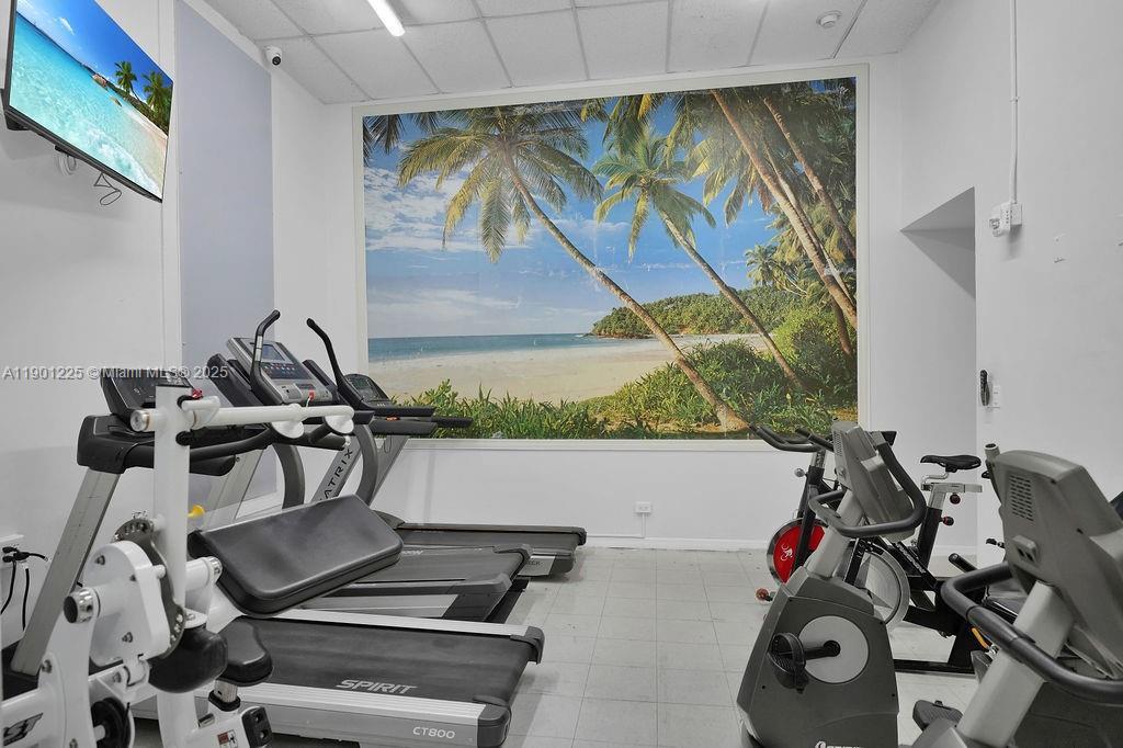 6039 Collins Avenue, Unit 1402 Miami Beach, FL 33140 - Photo 40 of 45 a view of a room with gym equipment