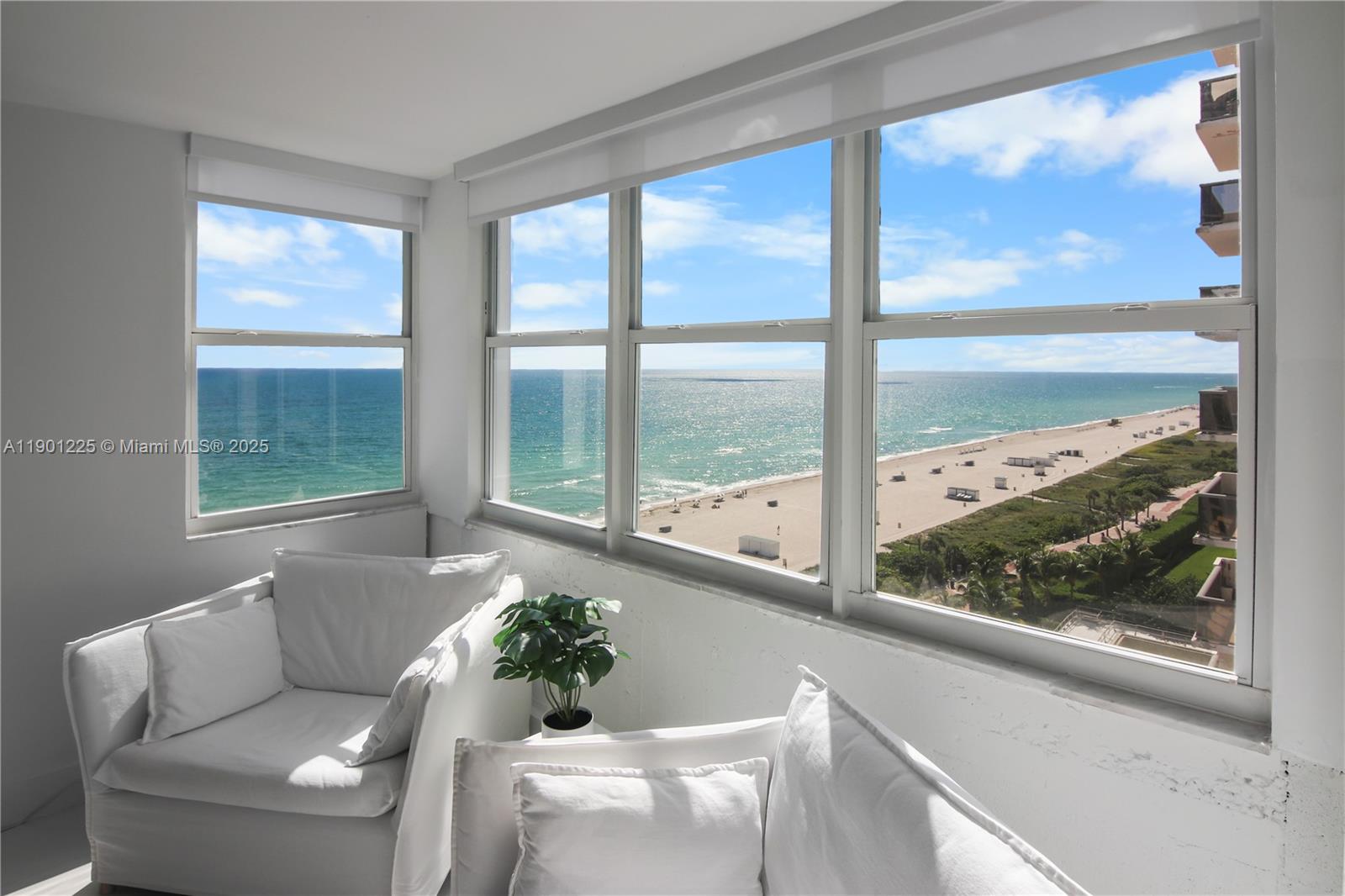 6039 Collins Avenue, Unit 1402 Miami Beach, FL 33140 - Photo 4 of 45 a living room with furniture and a large window