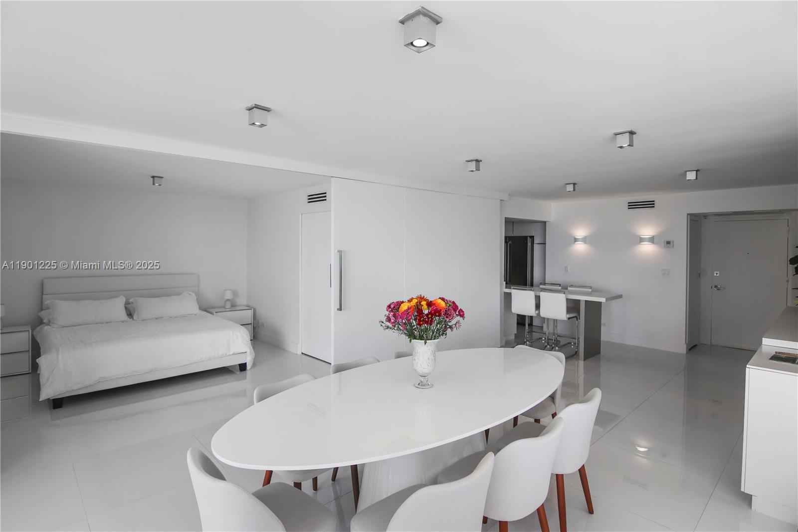 6039 Collins Avenue, Unit 1402 Miami Beach, FL 33140 - Photo 9 of 45 a living room with furniture and a dining table with wooden floor