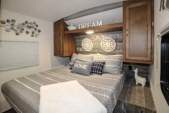 a bedroom with a bed and a table with chair