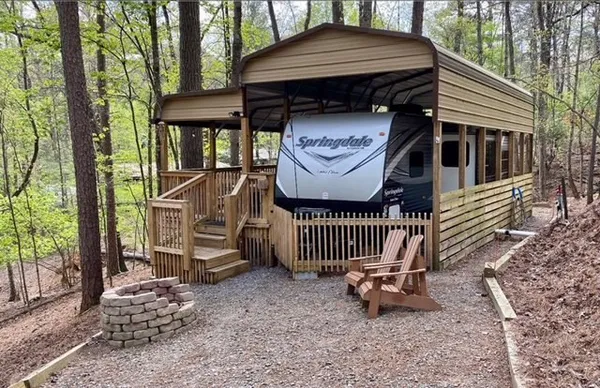 a front view of a house with garden and deck