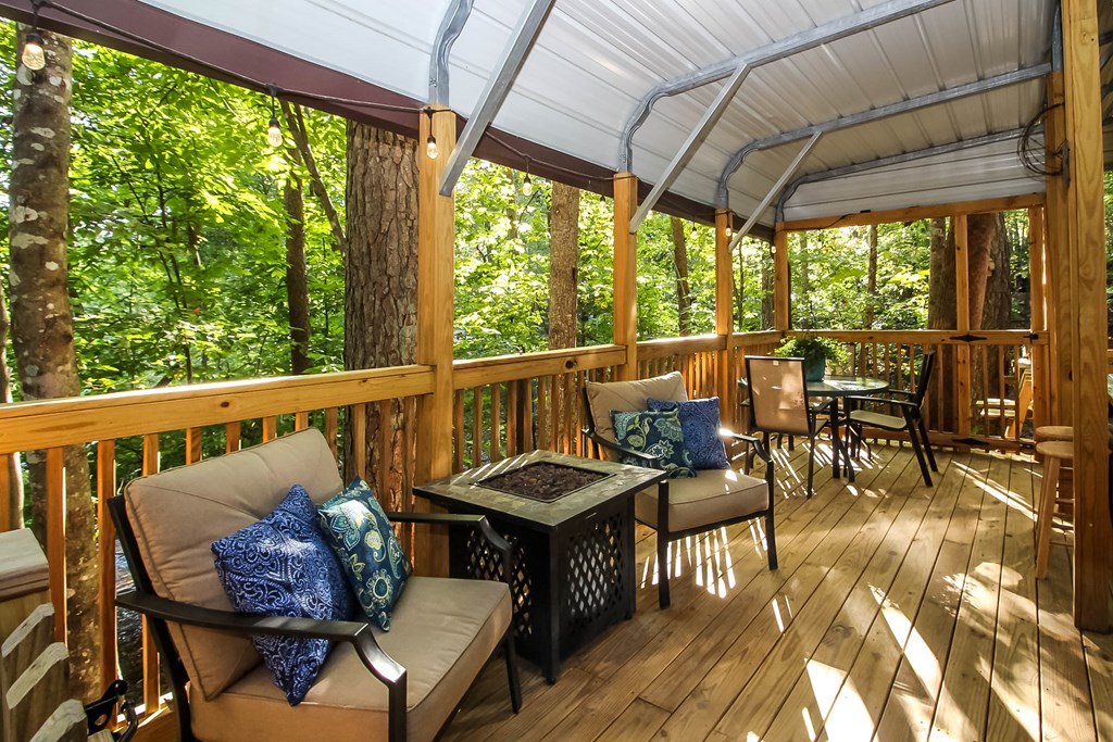 85 27th Street Ellijay, GA 30540 - Photo 4 of 28 a view of a patio with lawn chairs and a dining table with chairs