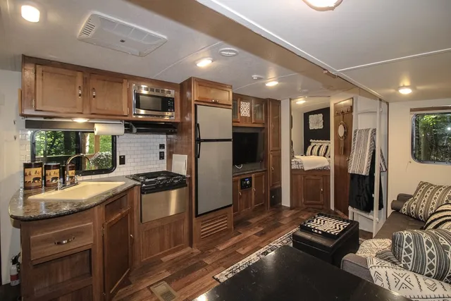 a kitchen with stainless steel appliances granite countertop a refrigerator stove and sink