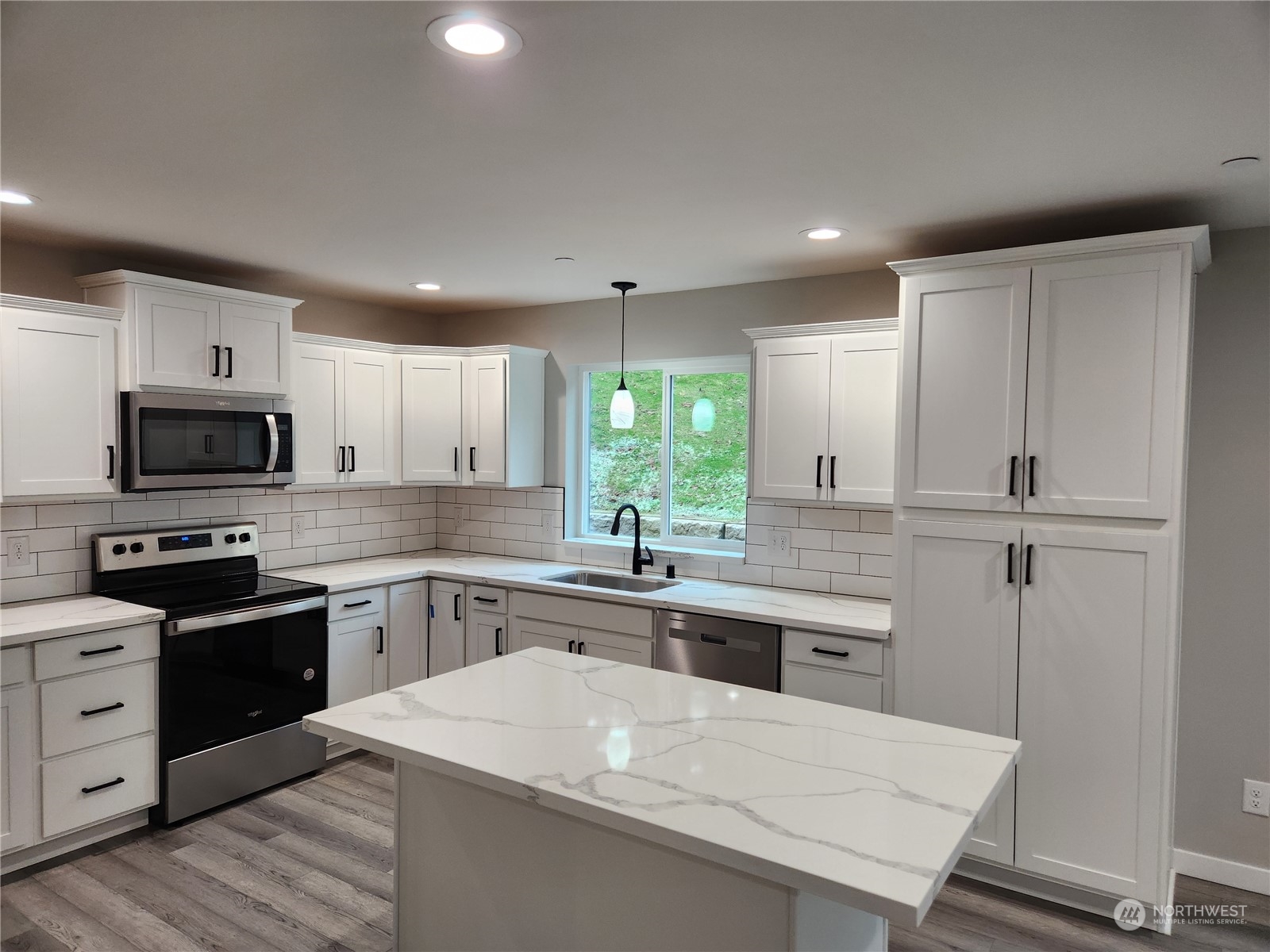5948 Sidney Road Southwest Port Orchard, WA 98367 - Photo 2 of 10 a kitchen with stainless steel appliances granite countertop a sink stove and refrigerator