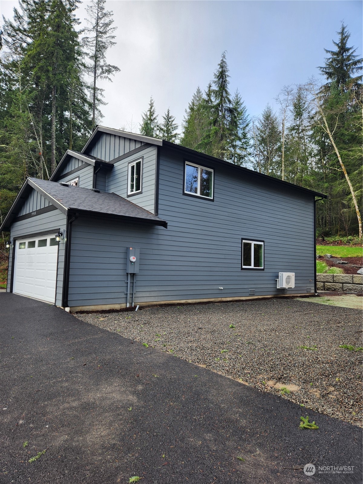 5948 Sidney Road Southwest Port Orchard, WA 98367 - Photo 9 of 10 a front view of a house with a yard and garage