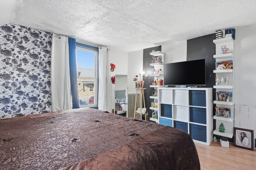 5 Ripley Place Worcester, MA 01610 - Photo 16 of 28 a bedroom with a bed and a flat screen tv