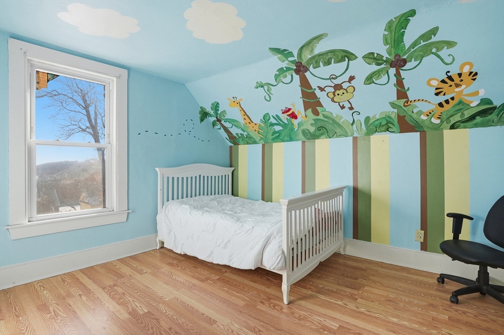 5 Ripley Place Worcester, MA 01610 - Photo 17 of 28 a bedroom with a bed table and a window