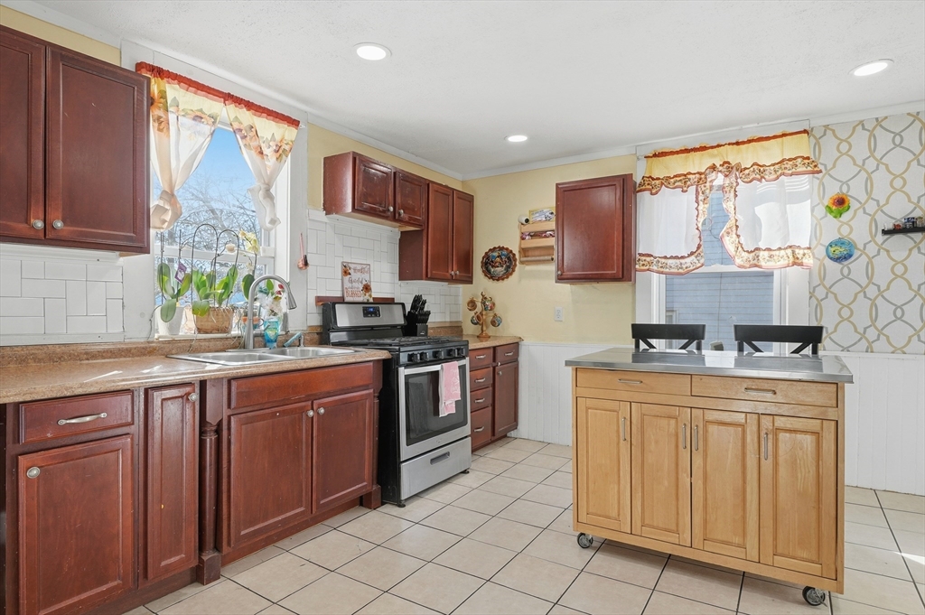 5 Ripley Place Worcester, MA 01610 - Photo 8 of 28 a kitchen with stainless steel appliances granite countertop a stove sink and cabinets