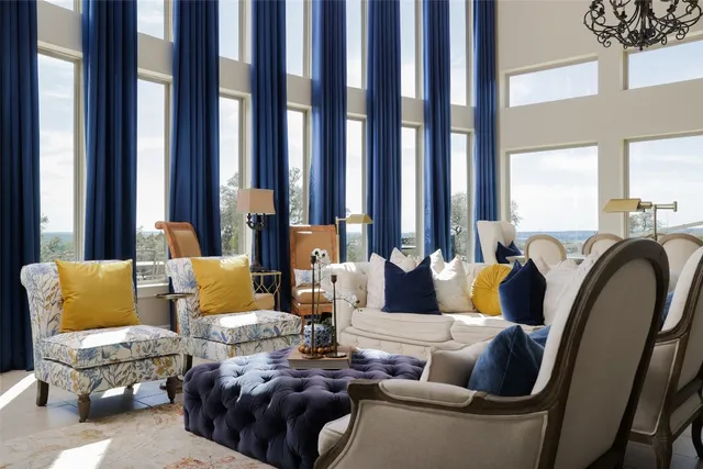 a living room with furniture and large windows