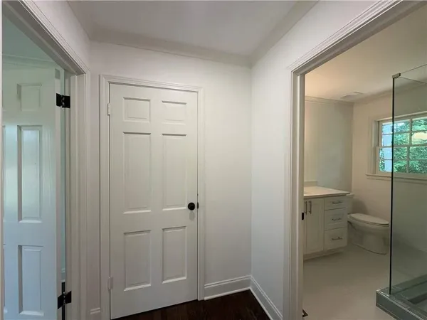 an empty room with wooden floor and window