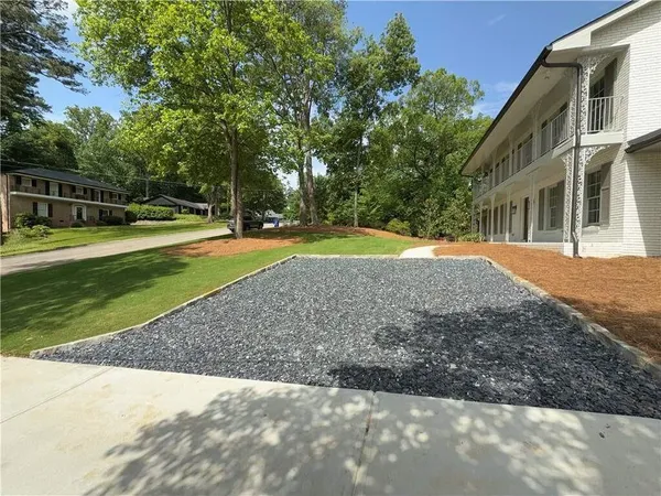 a view of a house with a backyard