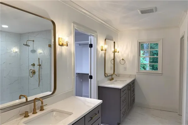 a bathroom with a shower a toilet and a sink