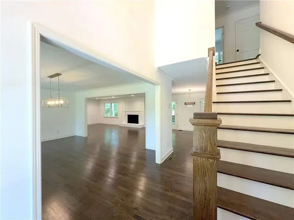 a view of entryway and hall with wooden floor
