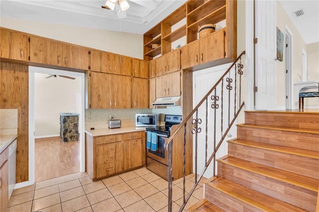 521 Pameto Road Nokomis, FL 34275 - Photo 12 of 41 a kitchen with cabinets and chairs