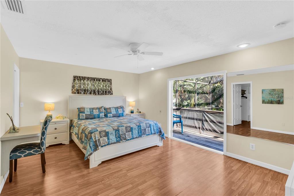 521 Pameto Road Nokomis, FL 34275 - Photo 13 of 41 a bedroom with a large bed and a chandelier
