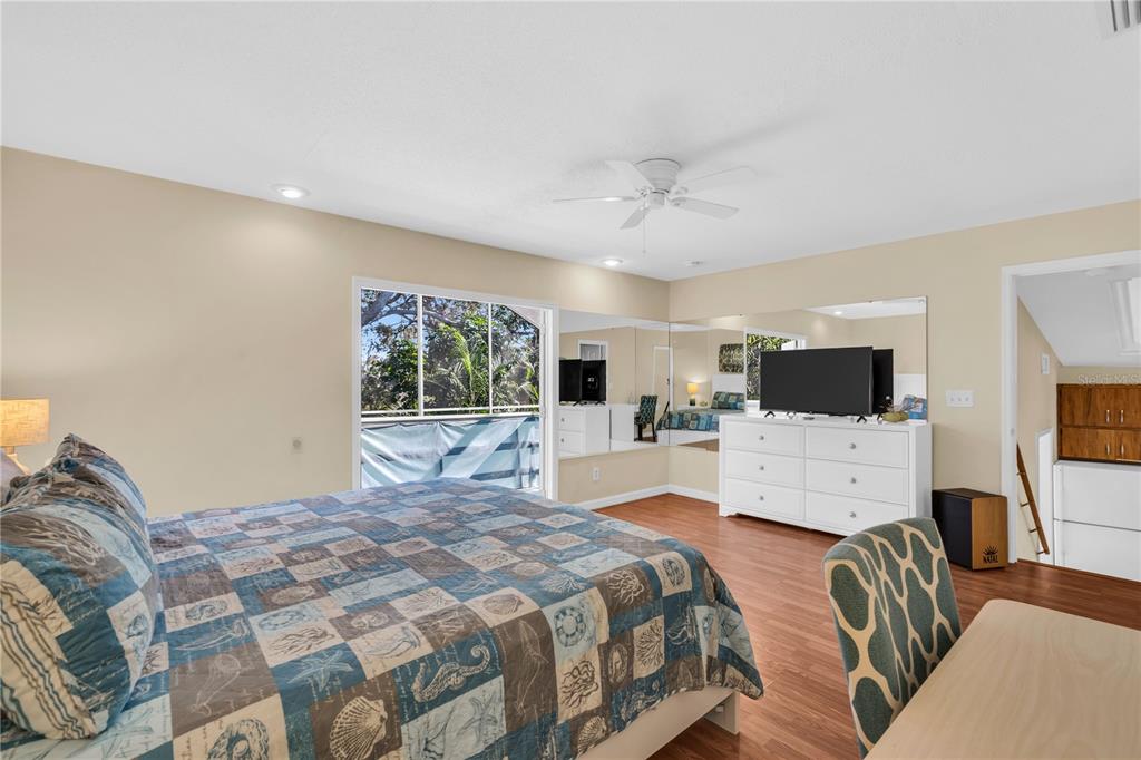 521 Pameto Road Nokomis, FL 34275 - Photo 14 of 41 a bedroom with a bed a couch and dresser