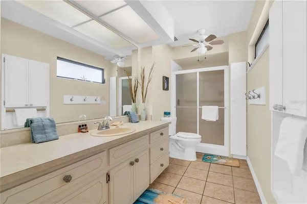 a spacious bathroom with a double vanity sink toilet and shower