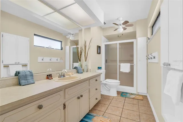a spacious bathroom with a double vanity sink toilet and shower