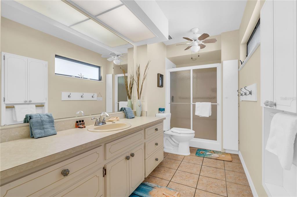 521 Pameto Road Nokomis, FL 34275 - Photo 15 of 41 a spacious bathroom with a double vanity sink toilet and shower