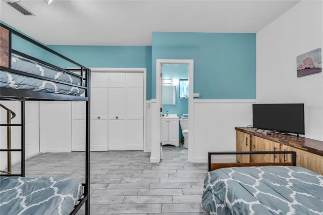 a bedroom with a bed and a flat screen tv