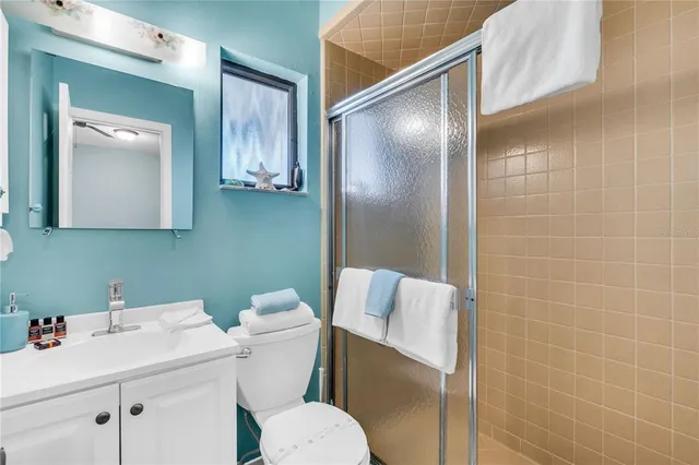 a bathroom with a sink mirror vanity and toilet