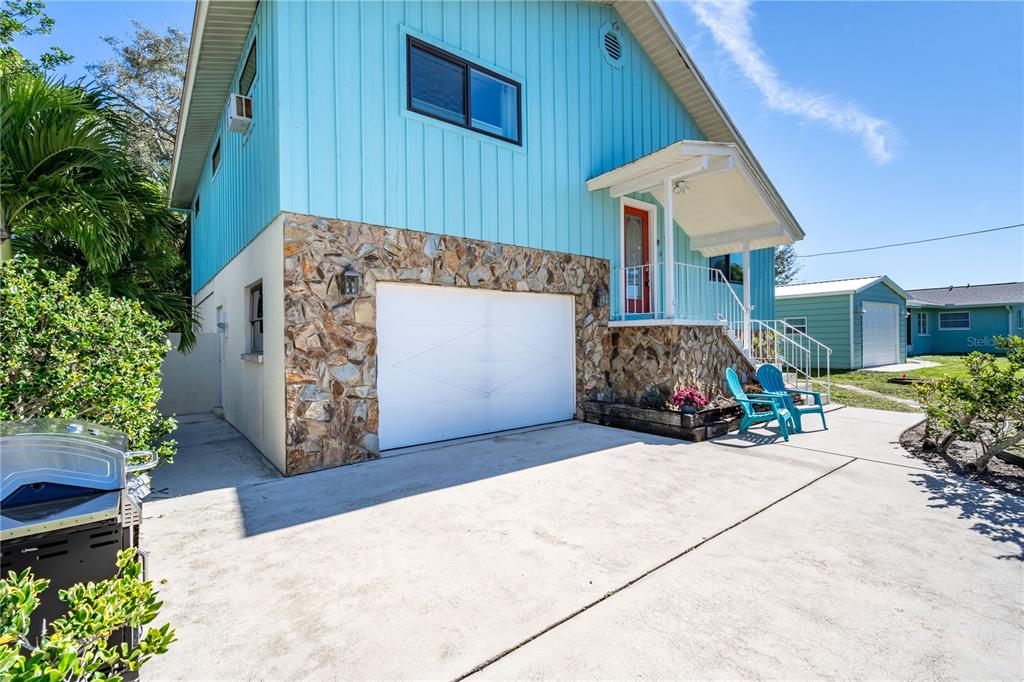 521 Pameto Road Nokomis, FL 34275 - Photo 2 of 41 a view of a house with potted plants and a garage