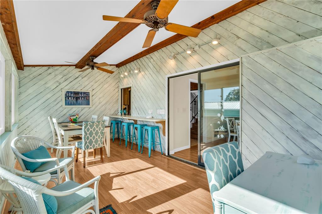 521 Pameto Road Nokomis, FL 34275 - Photo 22 of 41 a view of a patio with a table and chairs and wooden floor