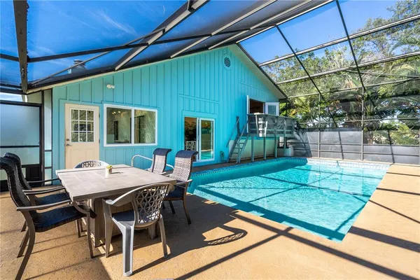 a view of a backyard with table and chairs
