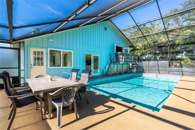 a view of a backyard with table and chairs