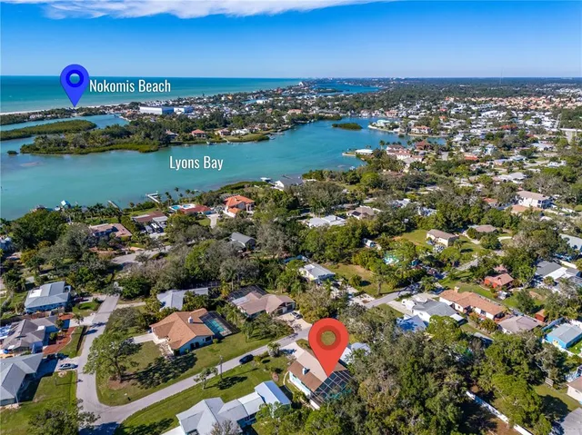 an aerial view of a houses with a lake view