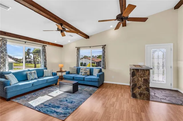 a living room with furniture and wooden floor