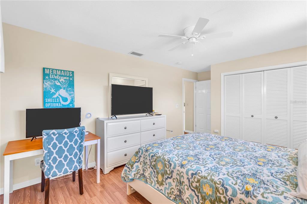 521 Pameto Road Nokomis, FL 34275 - Photo 8 of 41 a spacious bedroom with a bed and a flat screen tv