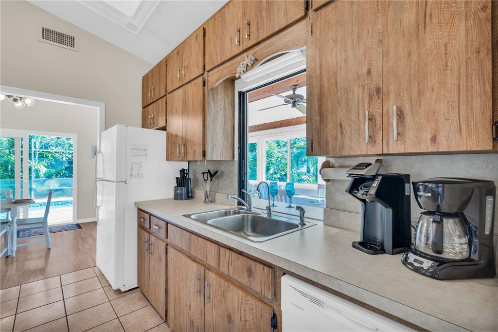 521 Pameto Road Nokomis, FL 34275 - Photo 10 of 41 a kitchen with a sink and a refrigerator
