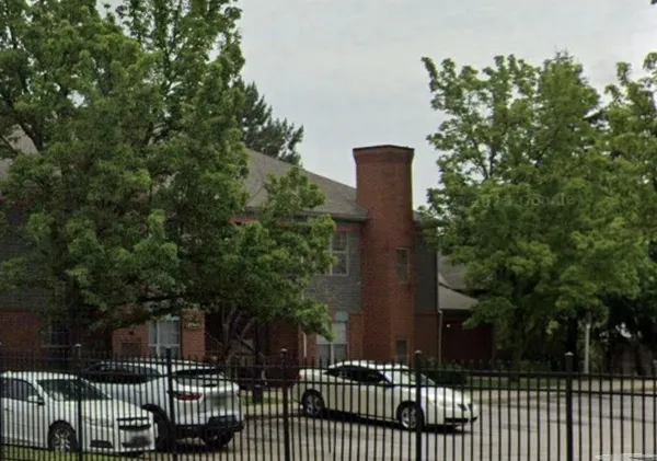 a view of a park with iron fence
