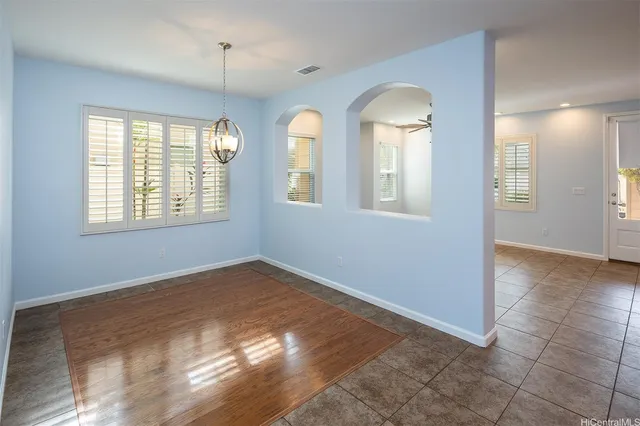 a view of a room with window and chandelier fan