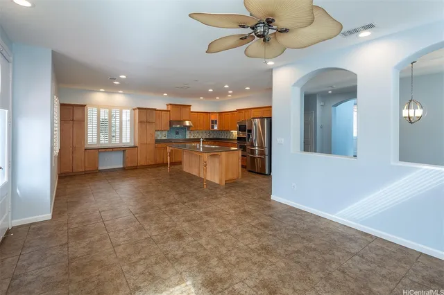 a view of a kitchen with a sink and a refrigerator