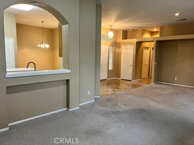 a view of a big room with windows and refrigerator