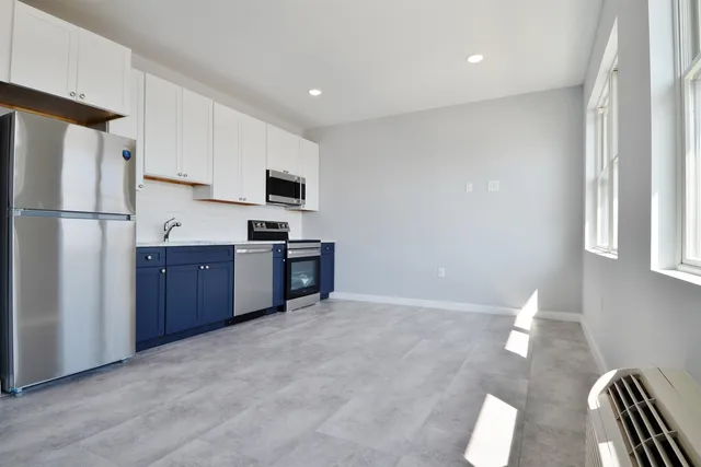 a kitchen with stainless steel appliances a refrigerator and a stove top oven